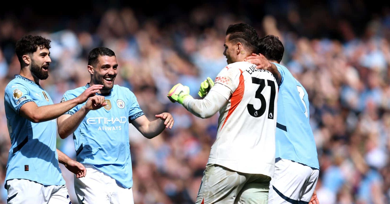 Man City goalkeeper Ederson celebrates with teammates Josko Gvardiol, Mateo Kovacic and Ruben Dias of Manchester City (obscured) following his assist for James McAtee's goal during the Premier League match between Manchester City FC and Crystal Palace FC at Etihad Stadium on April 12, 2025 in Manchester, England.