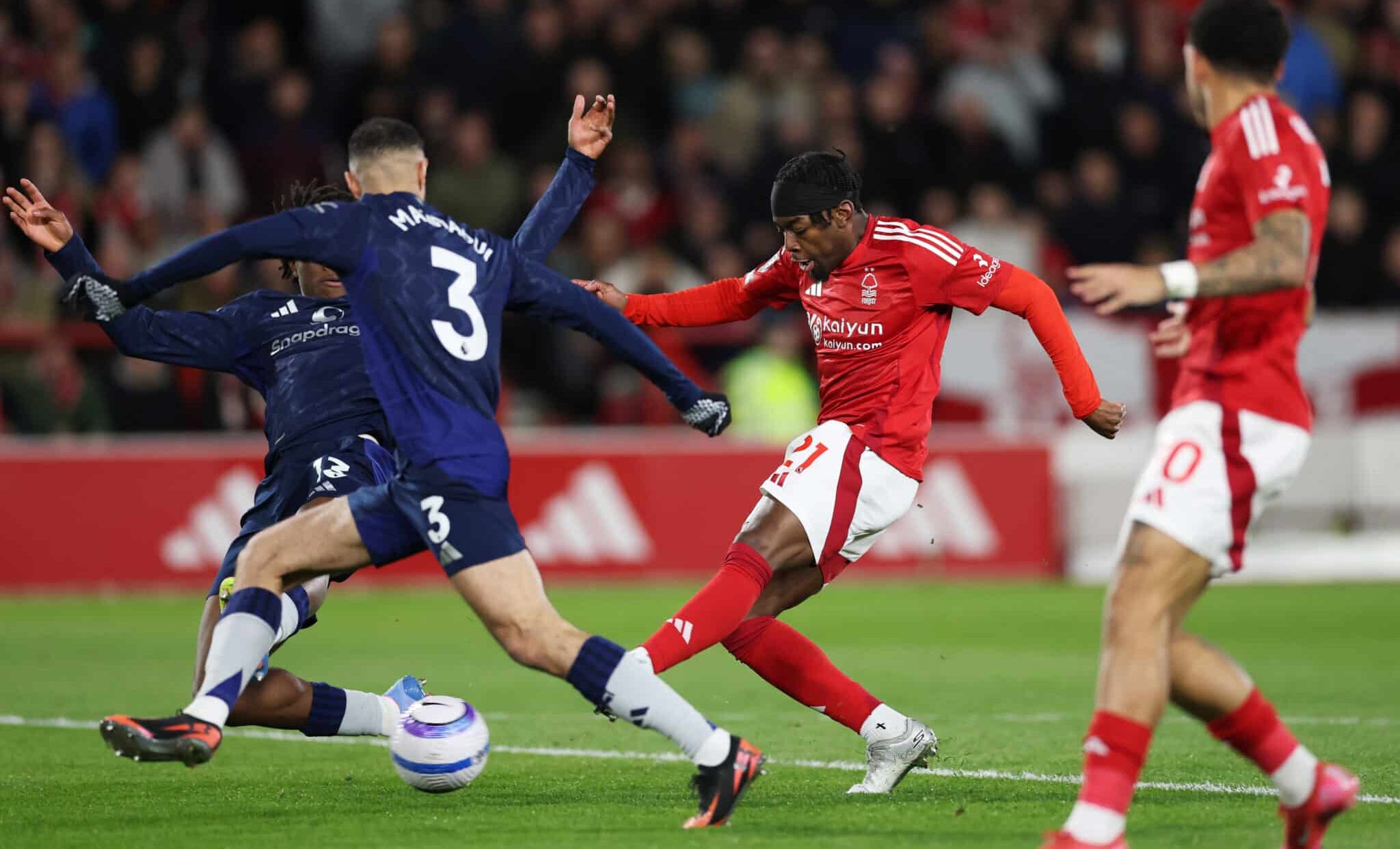 Anthony Elanga of Nottingham Forest scores his team's first goal as Patrick Chinazaekpere Dorgu and Noussair Mazraoui of Manchester United fail to block his shot during the Premier League match between Nottingham Forest FC and Manchester United FC at City Ground on April 01, 2025 in Nottingham, England.