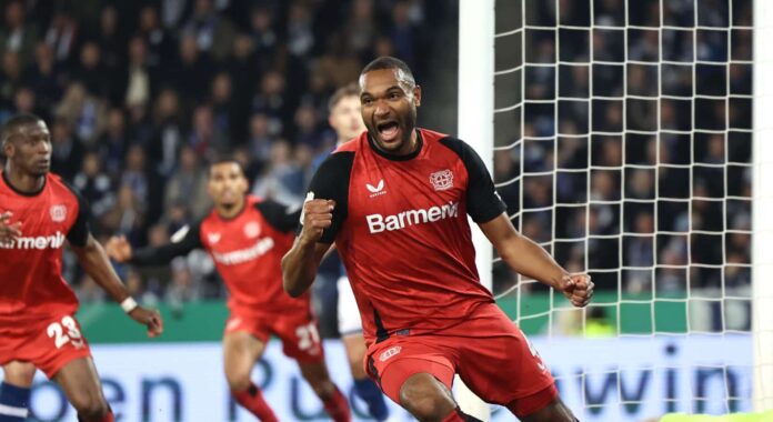 Jonathan Tah of Bayer 04 Leverkusen celebrates the team's first goal during the DFB Cup Semi Final between DSC Arminia Bielefeld and Bayer 04 Leverkusen at Schueco Arena on April 01, 2025 in Bielefeld, Germany.