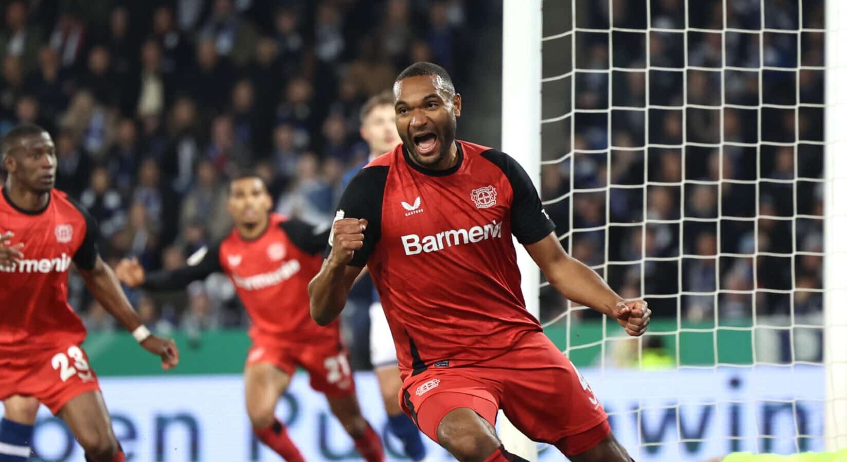 Jonathan Tah of Bayer 04 Leverkusen celebrates the team's first goal during the DFB Cup Semi Final between DSC Arminia Bielefeld and Bayer 04 Leverkusen at Schueco Arena on April 01, 2025 in Bielefeld, Germany.