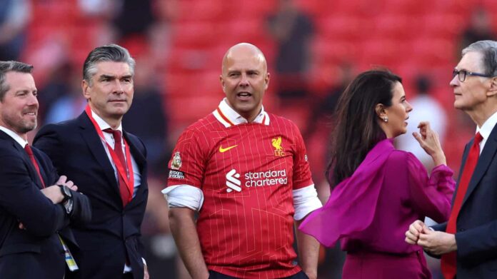 Arne Slot, Manager of Liverpool, speaks to the Liverpool owners after the team's victory and confirmation of winning the Premier League title in the Premier League match between Liverpool FC and Tottenham Hotspur FC at Anfield on April 27, 2025 in Liverpool, England.