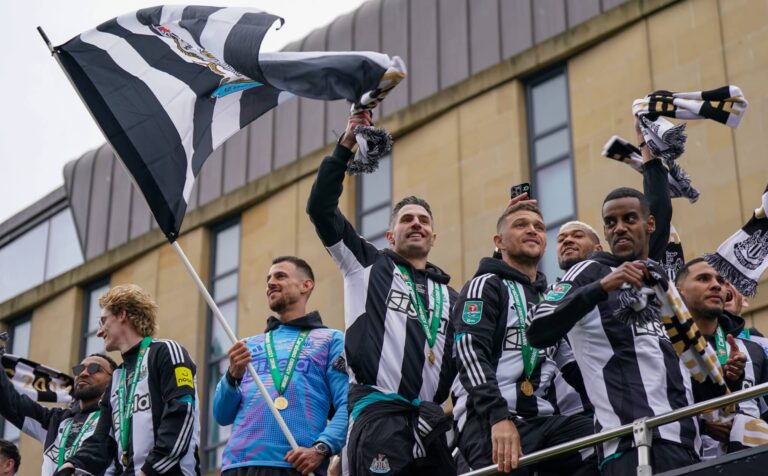 Newcastle United Football Club players Fabian Schar, Kieran Trippier and Alexander Isak react to fans during an open-top bus victory parade between St James’ Park and the Town Moor after their success in the Carabao Cup final on March 29, 2025 in Newcastle upon Tyne, England. Newcastle United defeated Liverpool in the Carabao Cup Final to end their seventy-year domestic trophy drought.