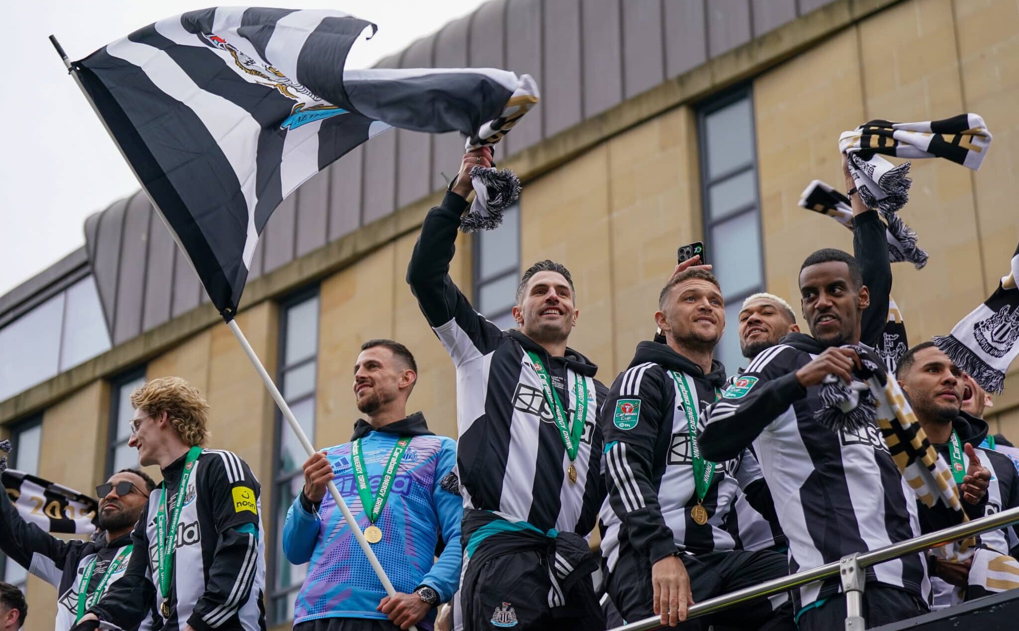Newcastle United Football Club players Fabian Schar, Kieran Trippier and Alexander Isak react to fans during an open-top bus victory parade between St James’ Park and the Town Moor after their success in the Carabao Cup final on March 29, 2025 in Newcastle upon Tyne, England. Newcastle United defeated Liverpool in the Carabao Cup Final to end their seventy-year domestic trophy drought.