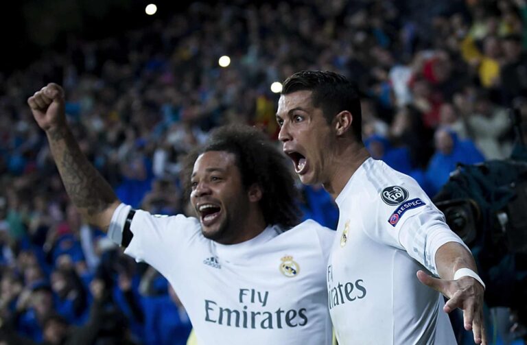 Former Real Madrid player Cristiano Ronaldo (R) celebrates scoring their third goal with teammate Marcelo (L) during the UEFA Champions League quarter final second leg match between Real Madrid CF and VfL Wolfsburg at Estadio Santiago Bernabeu on April 12, 2016 in Madrid, Spain.