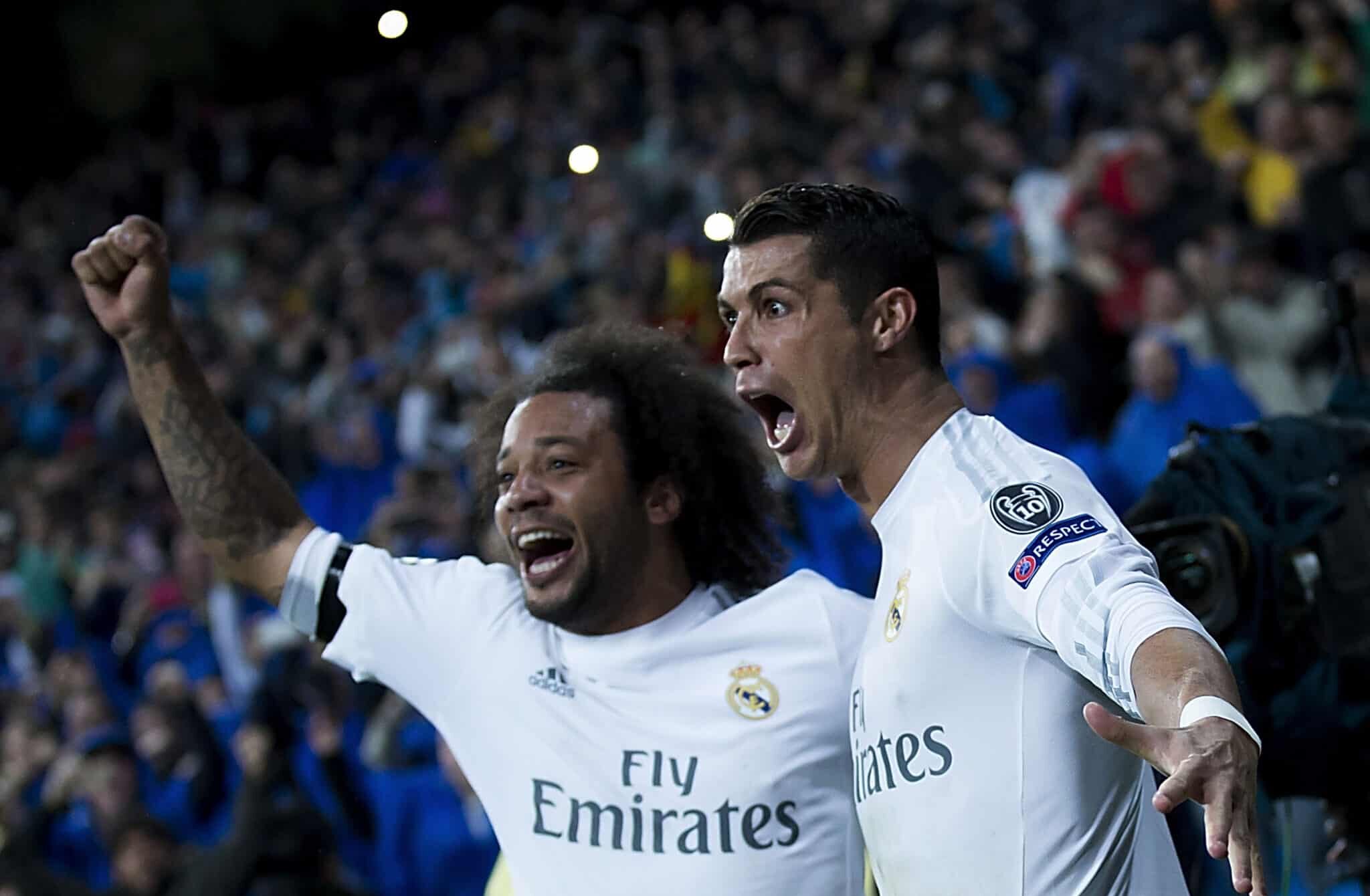 Former Real Madrid player Cristiano Ronaldo (R) celebrates scoring their third goal with teammate Marcelo (L) during the UEFA Champions League quarter final second leg match between Real Madrid CF and VfL Wolfsburg at Estadio Santiago Bernabeu on April 12, 2016 in Madrid, Spain.