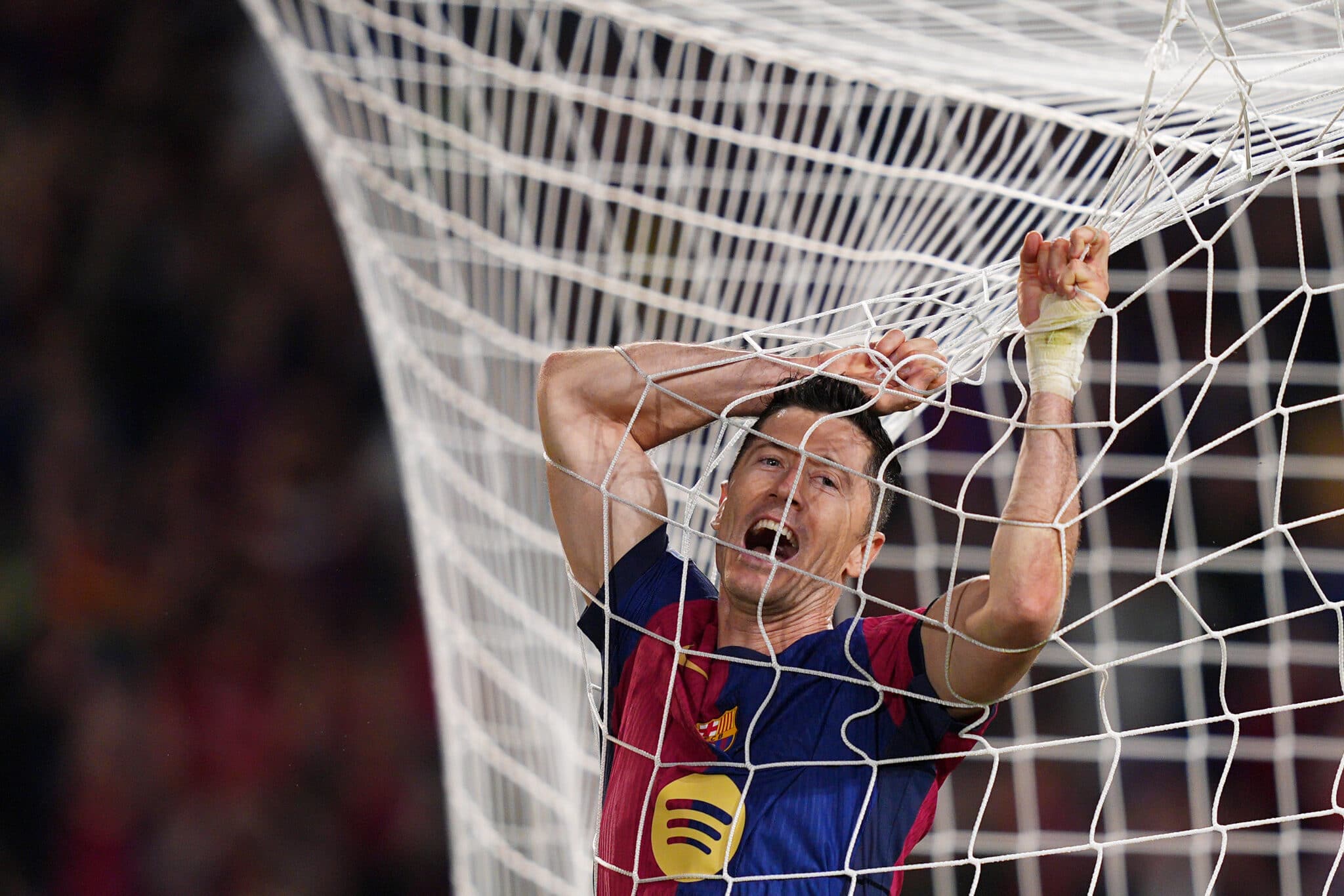 Robert Lewandowski of FC Barcelona reacts during the UEFA Champions League 2024/25 League Phase MD3 match between FC Barcelona and FC Bayern Munich at Estadi Olimpic Lluis Companys on October 23, 2024 in Barcelona, Spain.
