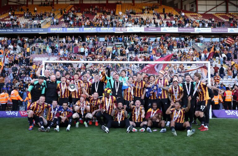 The Bradford City team celebrate victory and promotion following the Sky Bet League Two match between Bradford City and Fleetwood Town at University of Bradford Stadium on May 03, 2025 in Bradford, England.