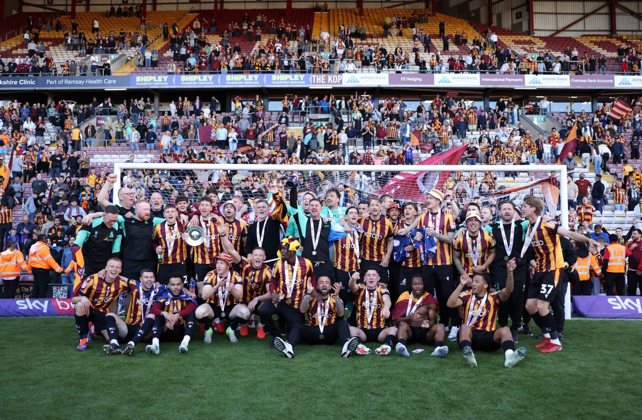 The Bradford City team celebrate victory and promotion following the Sky Bet League Two match between Bradford City and Fleetwood Town at University of Bradford Stadium on May 03, 2025 in Bradford, England.