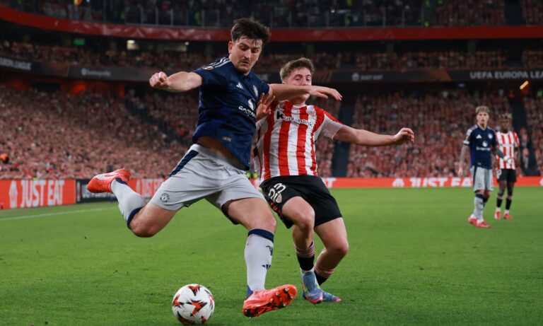 Harry Maguire of Manchester United is challenged by Daniel Vivian of Athletic Club during the UEFA Europa League 2024/25 Semi Final First Leg match between Athletic Bilbao and Manchester United at San Mames Stadium on May 01, 2025 in Bilbao, Spain.
