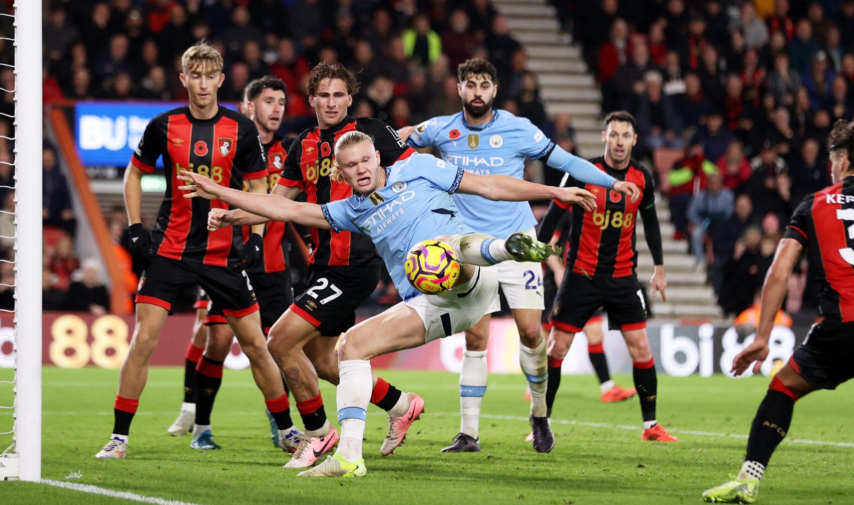 Manchester City striker Erling Haaland shoots whilst under pressure from Illya Zabarnyi of AFC Bournemouth during the Premier League match between AFC Bournemouth and Manchester City FC at Vitality Stadium on November 02, 2024 in Bournemouth, England.