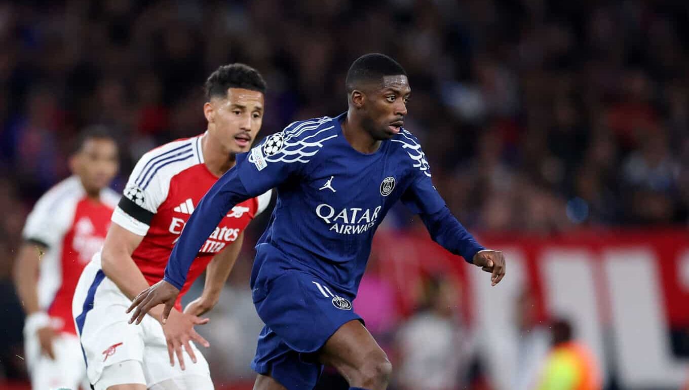 PSG player Ousmane Dembele runs with the ball whilst under pressure from William Saliba of Arsenal during the UEFA Champions League 2024/25 Semi Final First Leg match between Arsenal FC and Paris Saint-Germain at Emirates Stadium on April 29, 2025 in London, England.