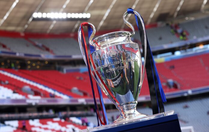 A detailed view of the UEFA Champions League trophy, which features ribbons in both teams colours, on the plinth prior to the UEFA Champions League Final 2025 between PSG and Inter Milan at Munich Football Arena on May 31, 2025 in Munich, Germany.