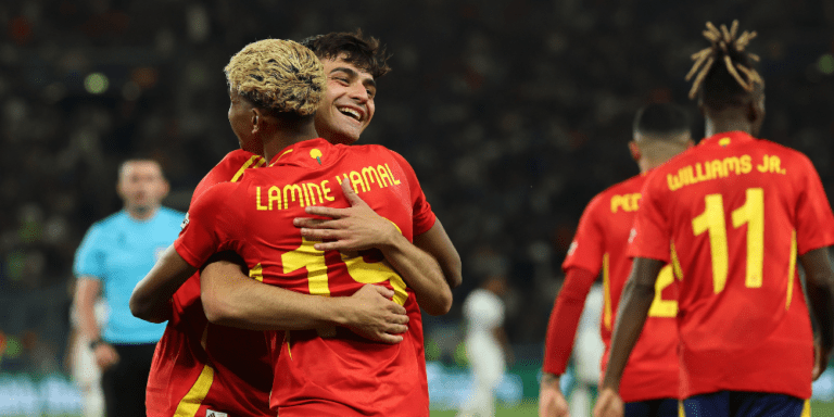 Spain players Pedri and Lamine Yamal embrace.