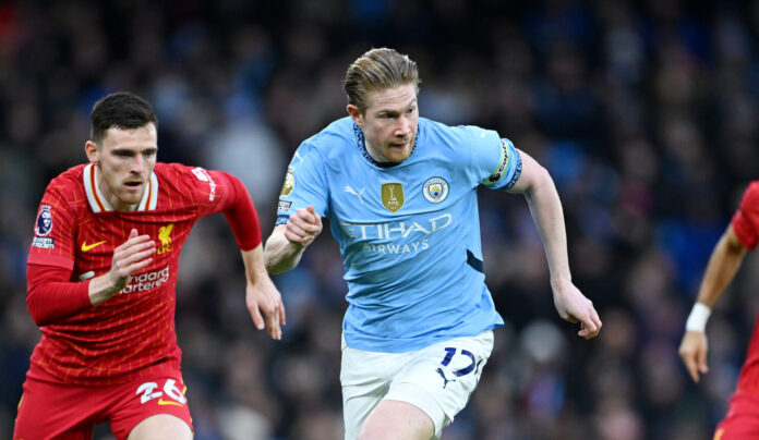 Liverpool - Kevin De Bruyne of Man City runs with the ball under pressure from Andrew Robertson of Liverpool during the Premier League match between Manchester City FC and Liverpool FC at Etihad Stadium on February 23, 2025 in Manchester, England.