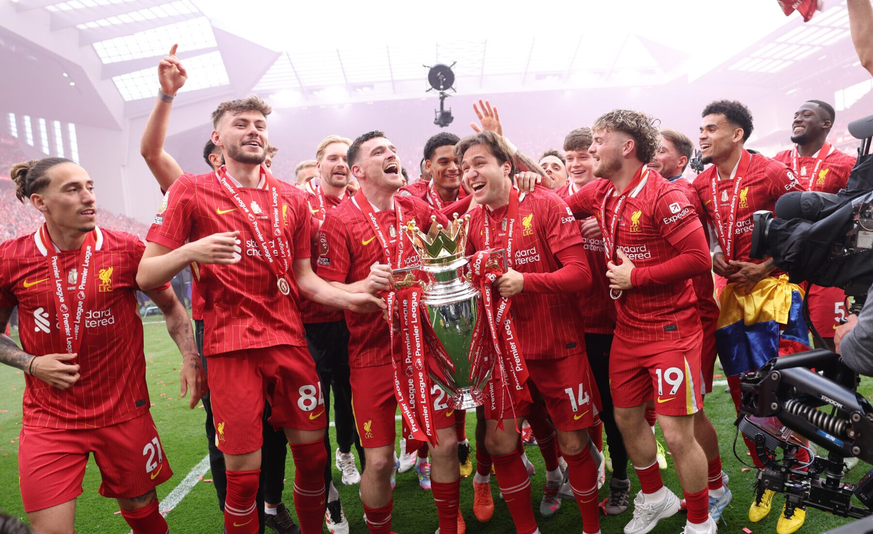 Liverpool players Andy Robertson and Federico Chiesa celebrate with Premier League trophy, as Liverpool are crowned the Champions of the Premier League for the 2024/25 Season, following the Premier League match between Liverpool FC and Crystal Palace FC at Anfield on May 25, 2025 in Liverpool, England.