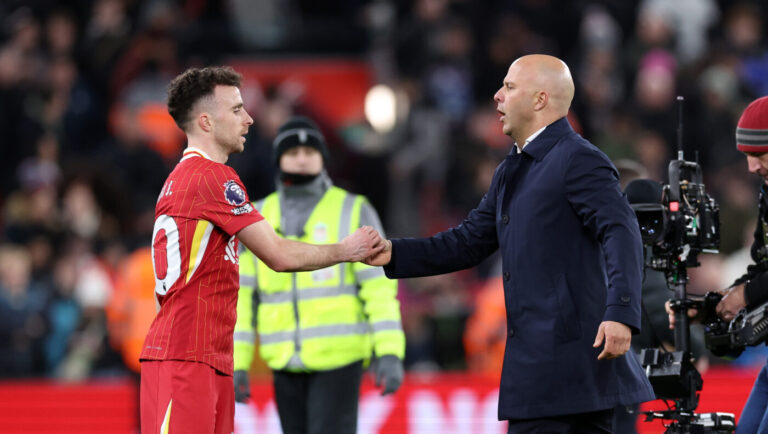 Arne Slot and Diogo Jota of Liverpool embrace after the draw during the Premier League match between Liverpool FC and Fulham FC at Anfield on December 14, 2024 in Liverpool, England.