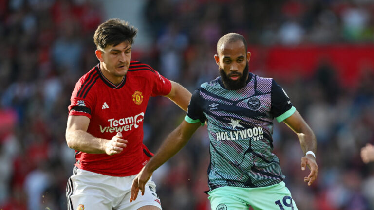 Manchester United - Bryan Mbeumo, formerly of Brentford, is challenged by Harry Maguire of Man United during the Premier League match between Manchester United and Brentford FC at Old Trafford on October 07, 2023 in Manchester, England.