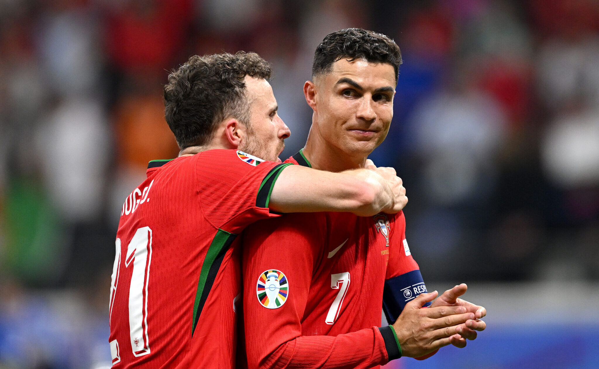 Cristiano Ronaldo and Diogo Jota of Portugal celebrate following the team's victory in the penalty shoot out during the UEFA EURO 2024 round of 16 match between Portugal and Slovenia at Frankfurt Arena on July 01, 2024 in Frankfurt am Main, Germany.