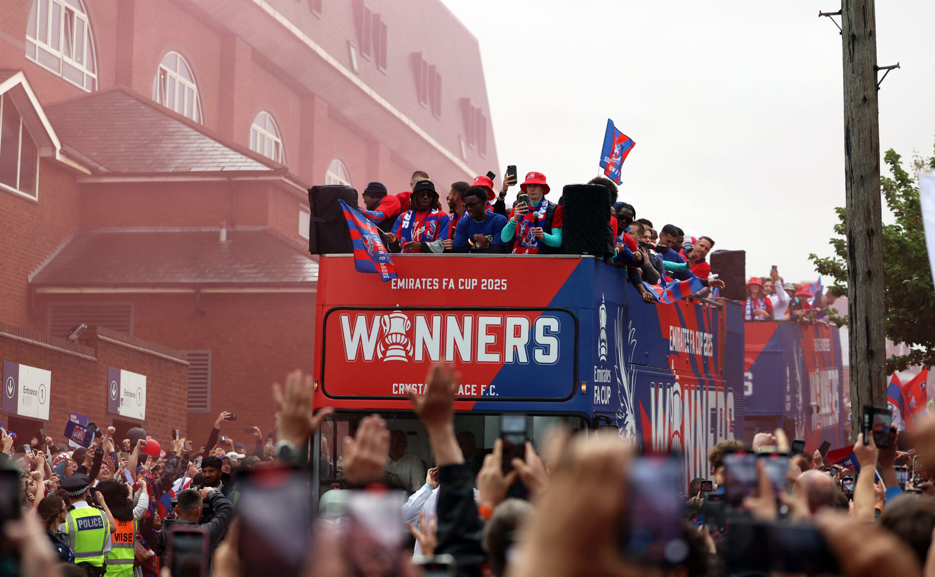 Crystal Palace - A general view as the team bus passes through fans in celebration on May 26, 2025 in London, England. Crystal Palace defeated Manchester City in the FA Cup Final in London on May 17.