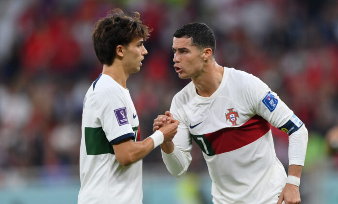 Footballers Cristiano Ronaldo of Portugal speaks with Joao Felix of Portugal during the FIFA World Cup Qatar 2022 quarter final match between Morocco/Spain and Portugal/Switzerland at Al Thumama Stadium on December 10, 2022 in Doha, Qatar.
