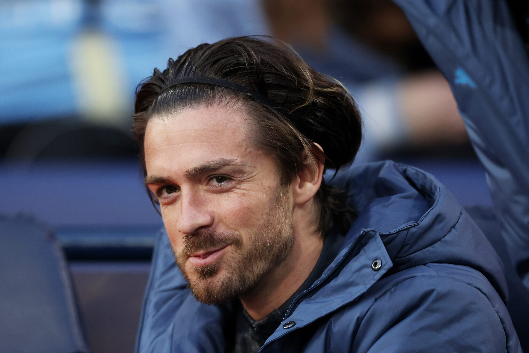 Jack Grealish of Man City looks on from the substitutes bench prior to the Premier League match between Manchester City FC and Aston Villa FC at Etihad Stadium on April 22, 2025 in Manchester, England.