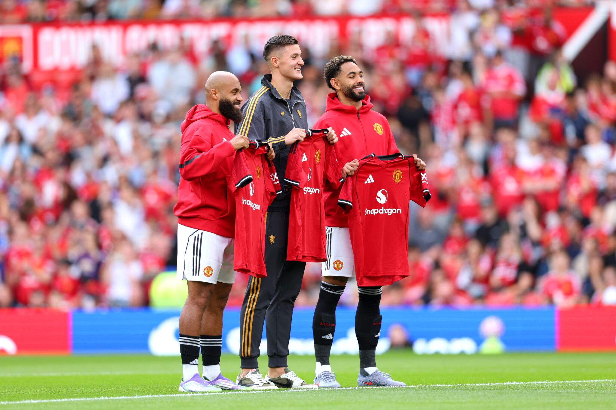 New Man Utd signings Bryan Mbeumo, Benjamin Sesko and Matheus Cunha pose for a photo while holding match shirts prior to the pre-season friendly match between Manchester United and ACF Fiorentina at Old Trafford on August 09, 2025 in Manchester, England.