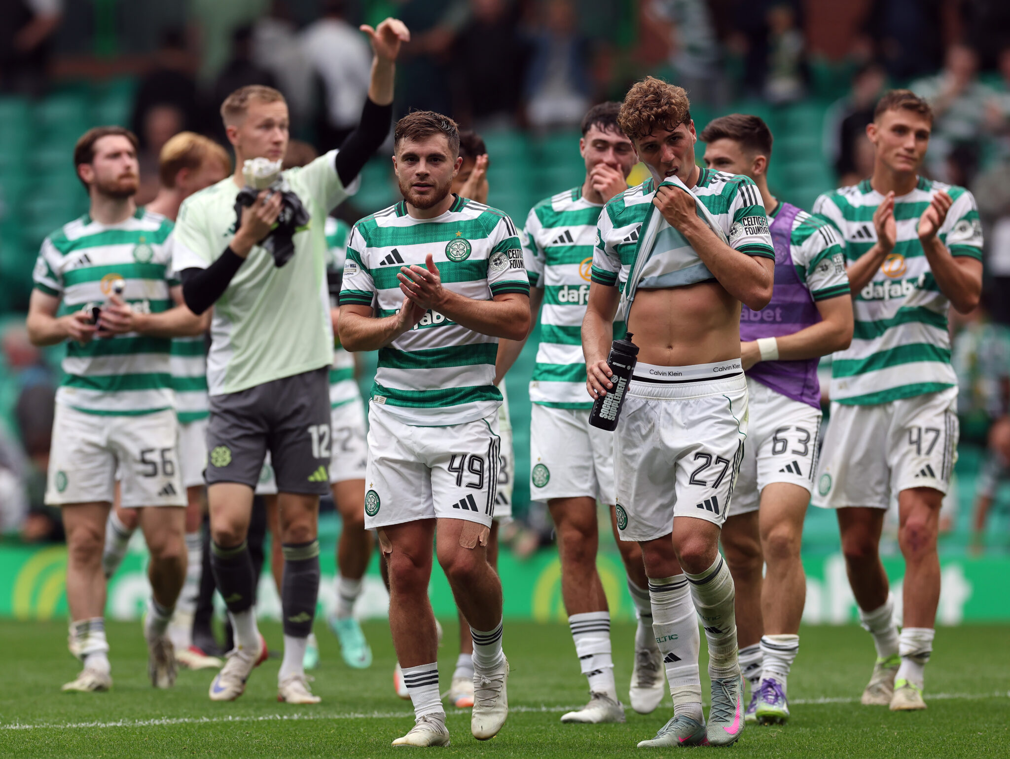 Celtic players look dejected at the end of a game.