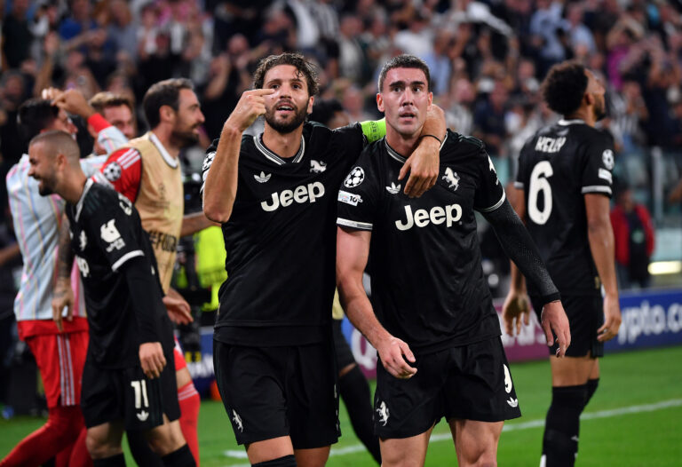 Juventus striker Dusan Vlahovic celebrates a goal with Manuel Locatelli.
