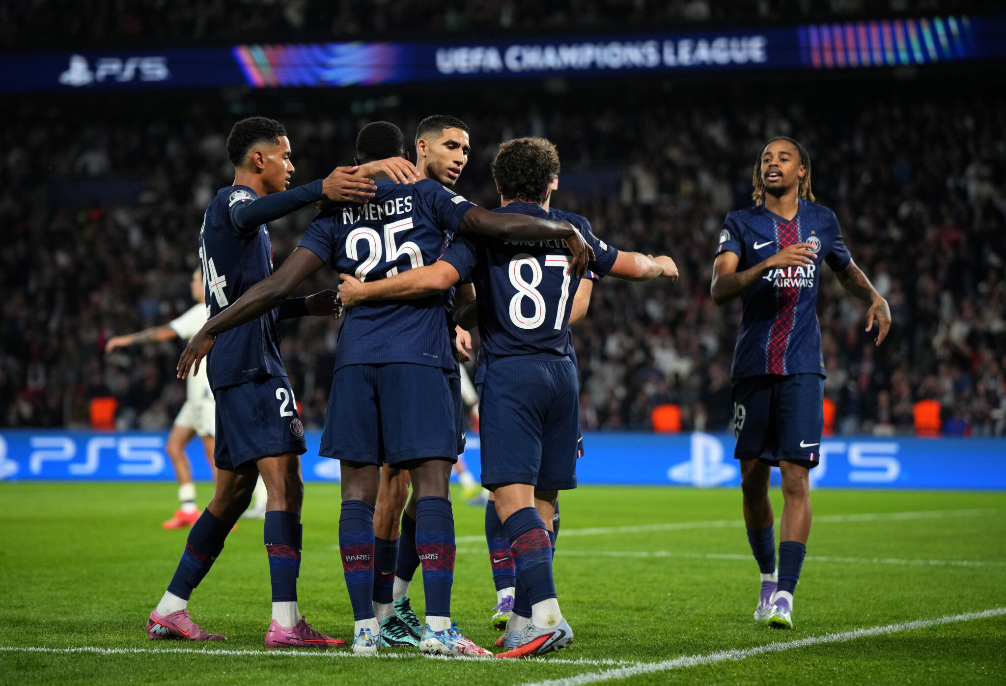 PSG players celebrate a goal together.