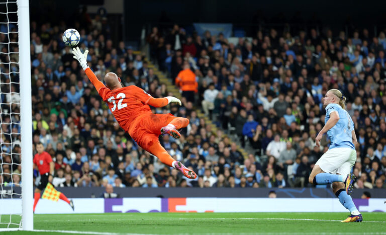 Champions League - Erling Haaland of Manchester City scores his team's first goal past Vanja Milinkovic-Savic of Napoli during the UEFA Champions League 2025/26 League Phase MD1 match between Manchester City and SSC Napoli at City of Manchester Stadium on September 18, 2025 in Manchester, England.