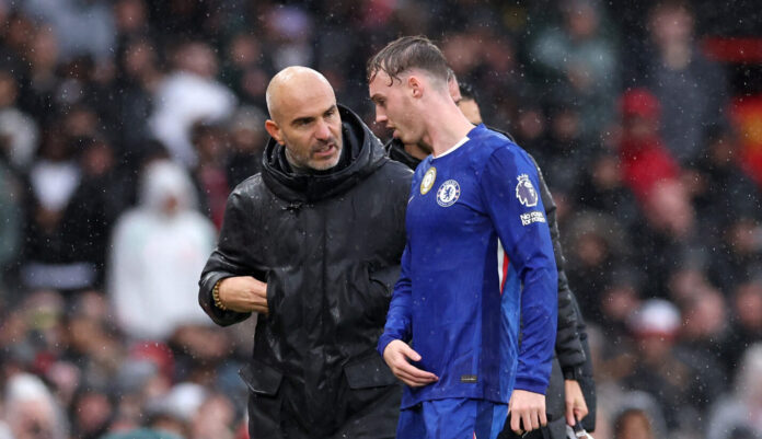 Chelsea manager Enzo Maresca and Cole Palmer of Chelsea talk after he was substituted during the Premier League match between Manchester United and Chelsea at Old Trafford on September 20, 2025 in Manchester, England.