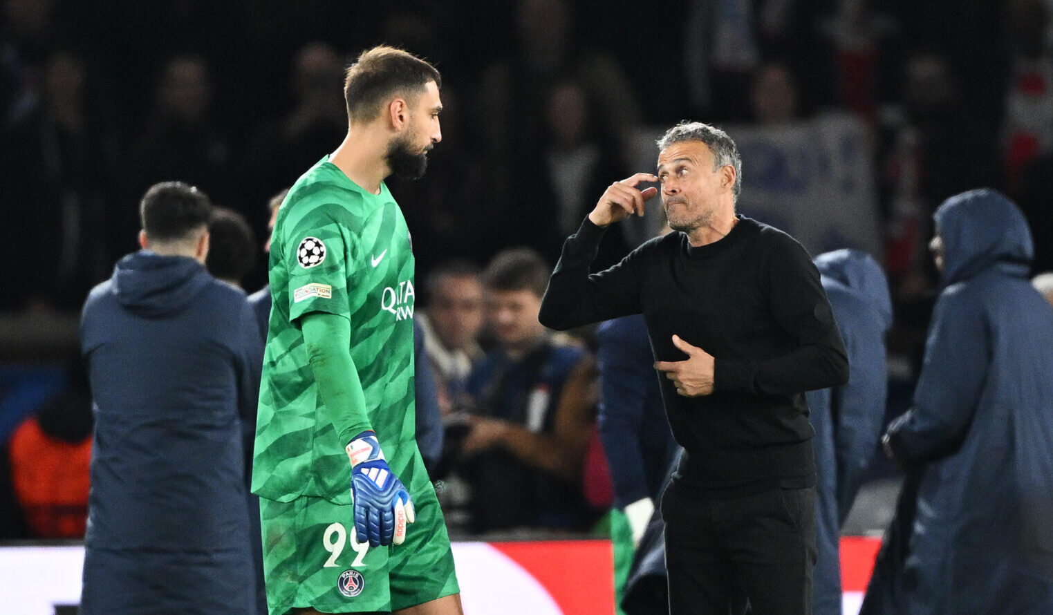 Luis Enrique, Head Coach of Paris Saint-Germain, interacts with Gianluigi Donnarumma of Paris Saint-Germain at full-time following their team's victory in the UEFA Champions League match between Paris Saint-Germain and AC Milan at Parc des Princes on October 25, 2023 in Paris, France.