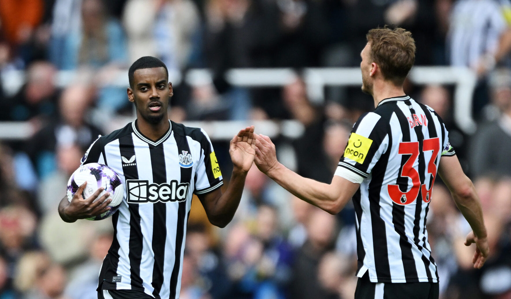 Newcastle United striker Alexander Isak celebrates scoring his team's first goal with teammate Dan Burn during the Premier League match between Newcastle United and Sheffield United at St. James Park on April 27, 2024 in Newcastle upon Tyne, England.