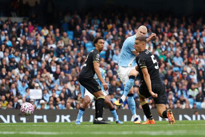 Premier League - Erling Haaland of Manchester City scores his team's fourth goal under pressure from Maxime Esteve of Burnley during the Premier League match between Manchester City and Burnley at Etihad Stadium on September 27, 2025 in Manchester, England.