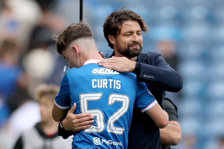 Russell Martin, Manager of Rangers interacts with Findlay Curtis of Rangers following the Premier League match between Rangers and Celtic at Ibrox Stadium on August 31, 2025 in Glasgow, Scotland.
