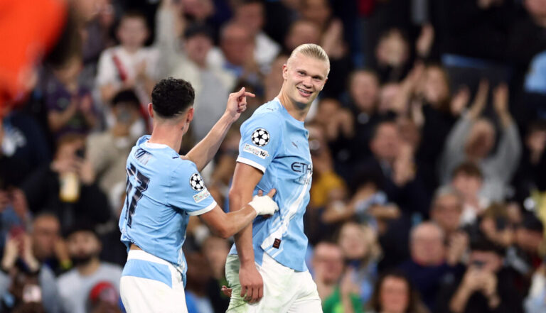 Erling Haaland of Manchester City celebrates scoring his team's first goal with teammate Phil Foden during the UEFA Champions League 2025/26 League Phase MD1 match between Manchester City and SSC Napoli at City of Manchester Stadium on September 18, 2025 in Manchester, England.