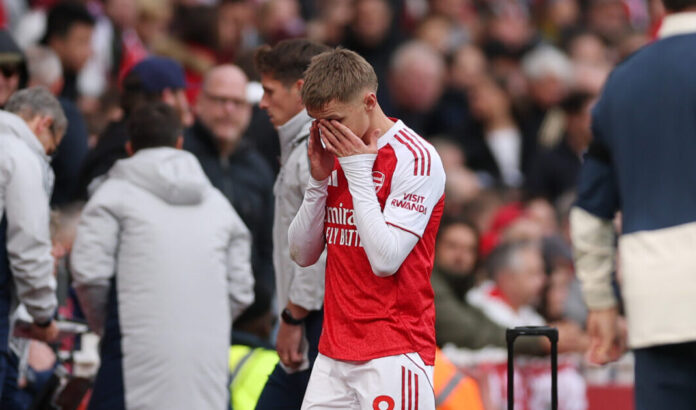 Arsenal captain Martin Odegaard looks dejected as he leaves the pitch injured during the Premier League match between Arsenal and West Ham United at Emirates Stadium on October 04, 2025 in London, England.