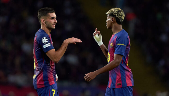Barcelona players Ferran Torres and Lamine Yamal interact during the UEFA Champions League 2025/26 League Phase MD2 match between FC Barcelona and Paris Saint-Germain at Estadi Olimpic Lluis Companys on October 01, 2025 in Barcelona, Spain.