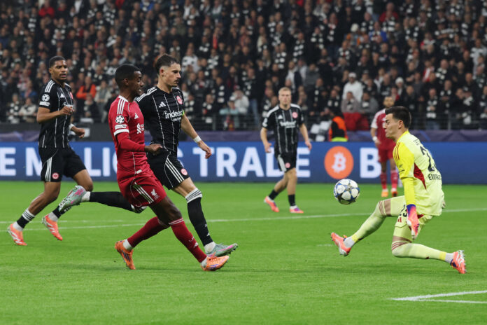 Liverpool - Michael Zetterer of Eintracht Frankfurt makes a save from Alexander Isak of Liverpool whilst under pressure from Robin Koch during the UEFA Champions League 2025/26 League Phase MD3 match between Eintracht Frankfurt and Liverpool FC at Frankfurt Stadion on October 22, 2025 in Frankfurt am Main, Germany.