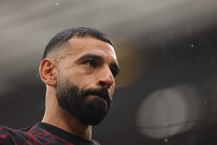 Liverpool star Mo Salah looks on as he warms up prior to the Premier League match between Liverpool and Everton at Anfield on September 20, 2025 in Liverpool, England.