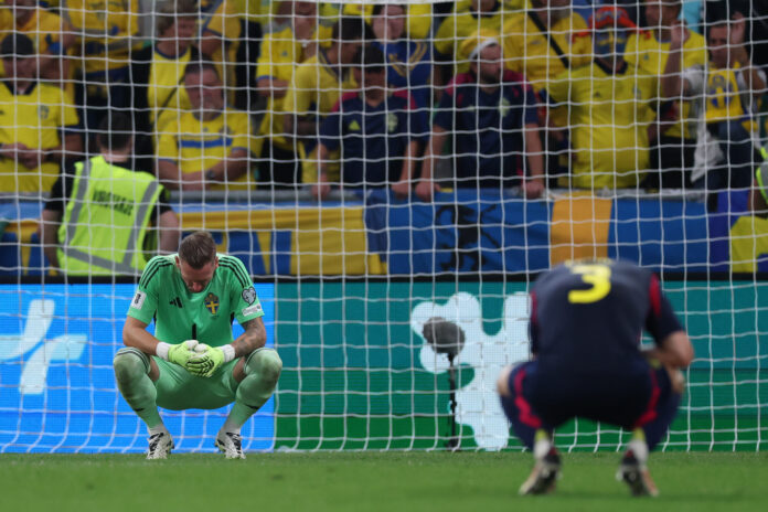 Robin Olsen of Sweden (L) reacts at the final whistle of the FIFA World Cup 2026 qualifier match between Slovenia and Sweden at Stozice Stadium on September 05, 2025 in Ljubljana, Slovenia.