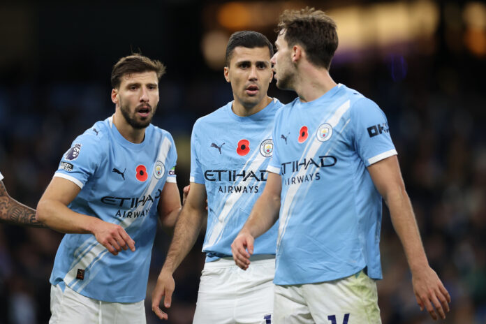 Man City player Rodrigo (c) alongside Ruben Dias (l) and Nico Gonzalez during the Premier League match between Manchester City and Bournemouth at Etihad Stadium on November 02, 2025 in Manchester, England.