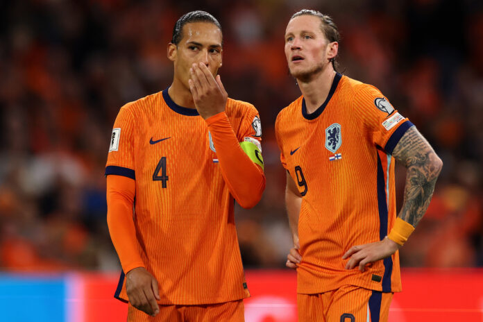 Netherlands players Virgil van Dijk and Wout Weghorst in conversation during a match.