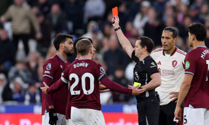 West Ham United player Lucas Paqueta receives a red card rom referee Darren England during the Premier League match between West Ham and Liverpool at the London Stadium.