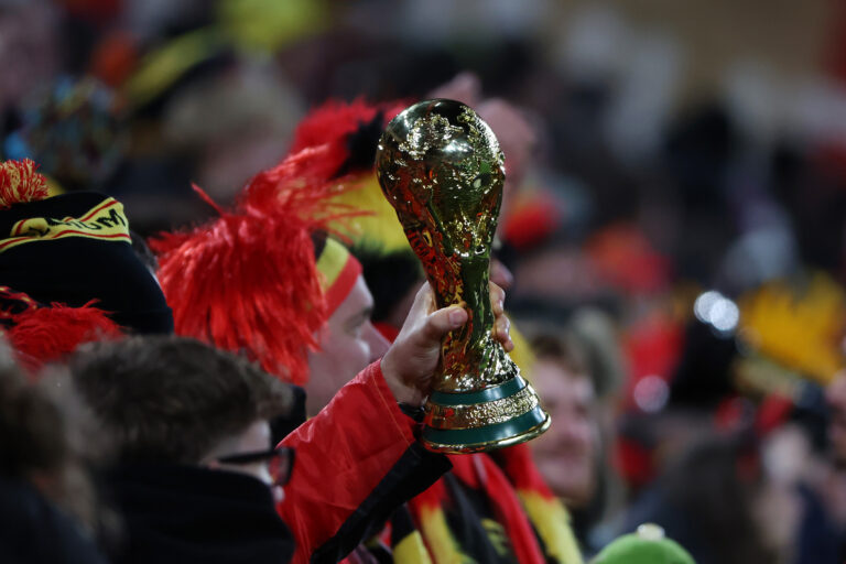 A Belgium fan holds a replica statue of the World Cup in the stands during the FIFA World Cup 2026 qualifier match between Belgium and Liechtenstein on November 18, 2025 in Liege, Belgium.