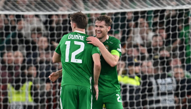 Nathan Collins and James Dunne of Republic of Ireland react after the team's victory during the FIFA World Cup 2026 qualifier match between Republic of Ireland and Portugal at Aviva Stadium on November 13, 2025 in Dublin, Ireland.