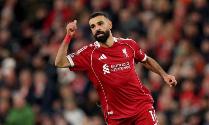 Mo Salah of Liverpool shows a thumbs up to his teammate during the Premier League match between Liverpool and Brighton & Hove Albion at Anfield on December 13, 2025 in Liverpool, England.