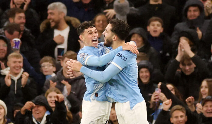 Man City player Phil Foden celebrates scoring his team's third goal with teammate Rayan Cherki during the Premier League match between Manchester City and Sunderland at Etihad Stadium on December 06, 2025 in Manchester, England.