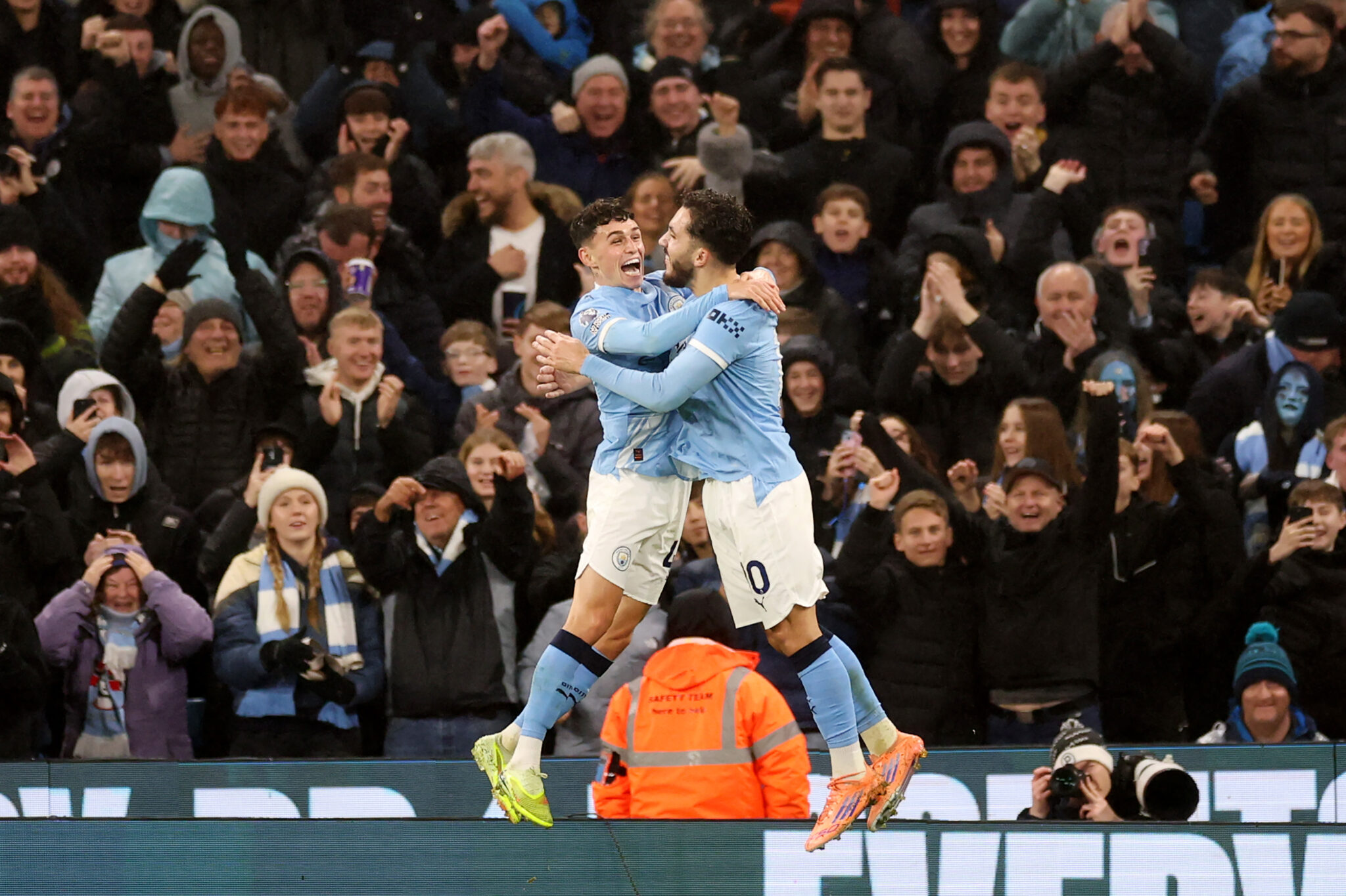Man City player Phil Foden celebrates scoring his team's third goal with teammate Rayan Cherki during the Premier League match between Manchester City and Sunderland at Etihad Stadium on December 06, 2025 in Manchester, England.