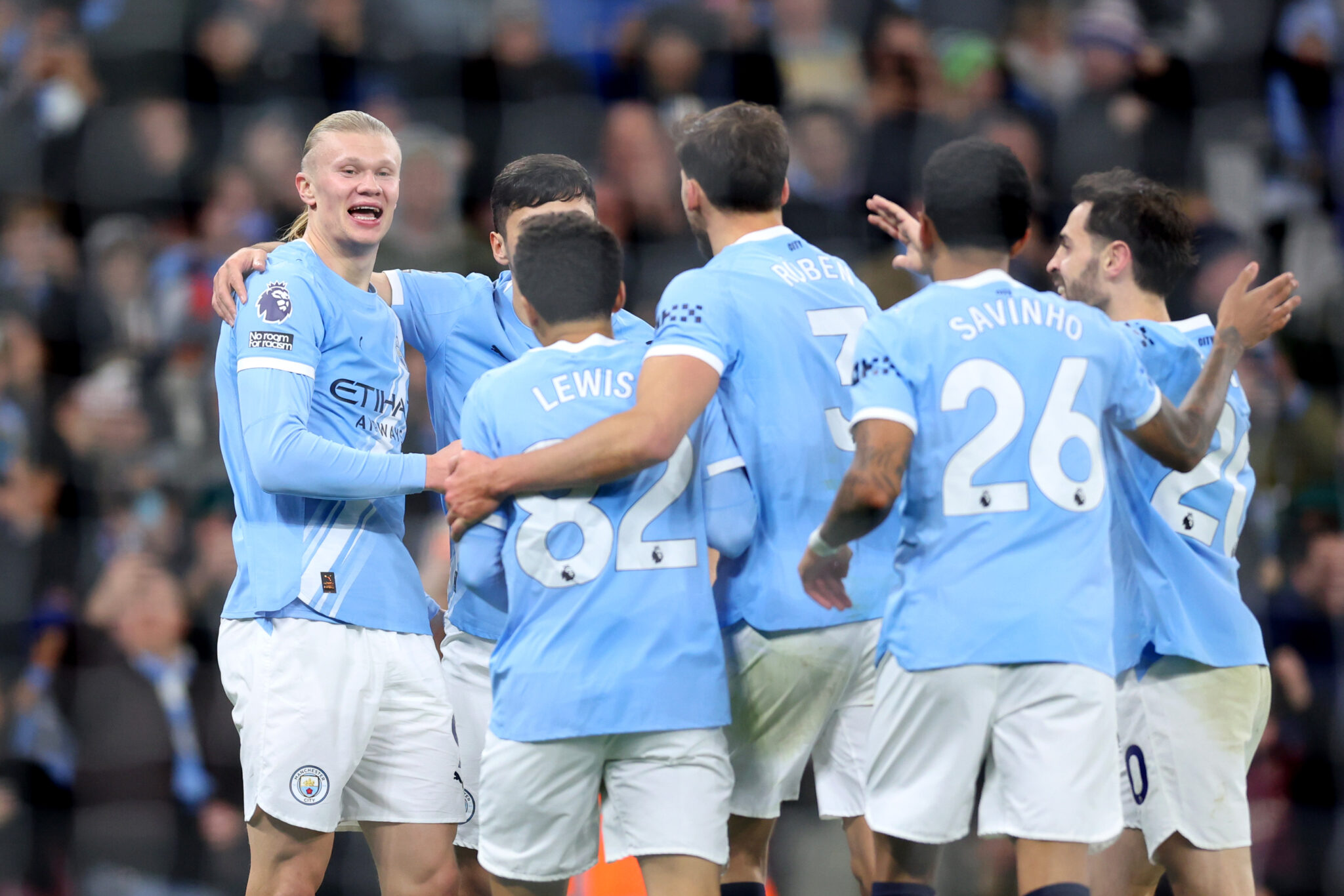 Man City striker Erling Haaland (L) celebrates scoring his team's third goal with teammates during the Premier League match between Manchester City and West Ham United at Etihad Stadium on December 20, 2025 in Manchester, England.